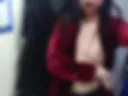 sexy breasts in a fitting room in a red jacket
